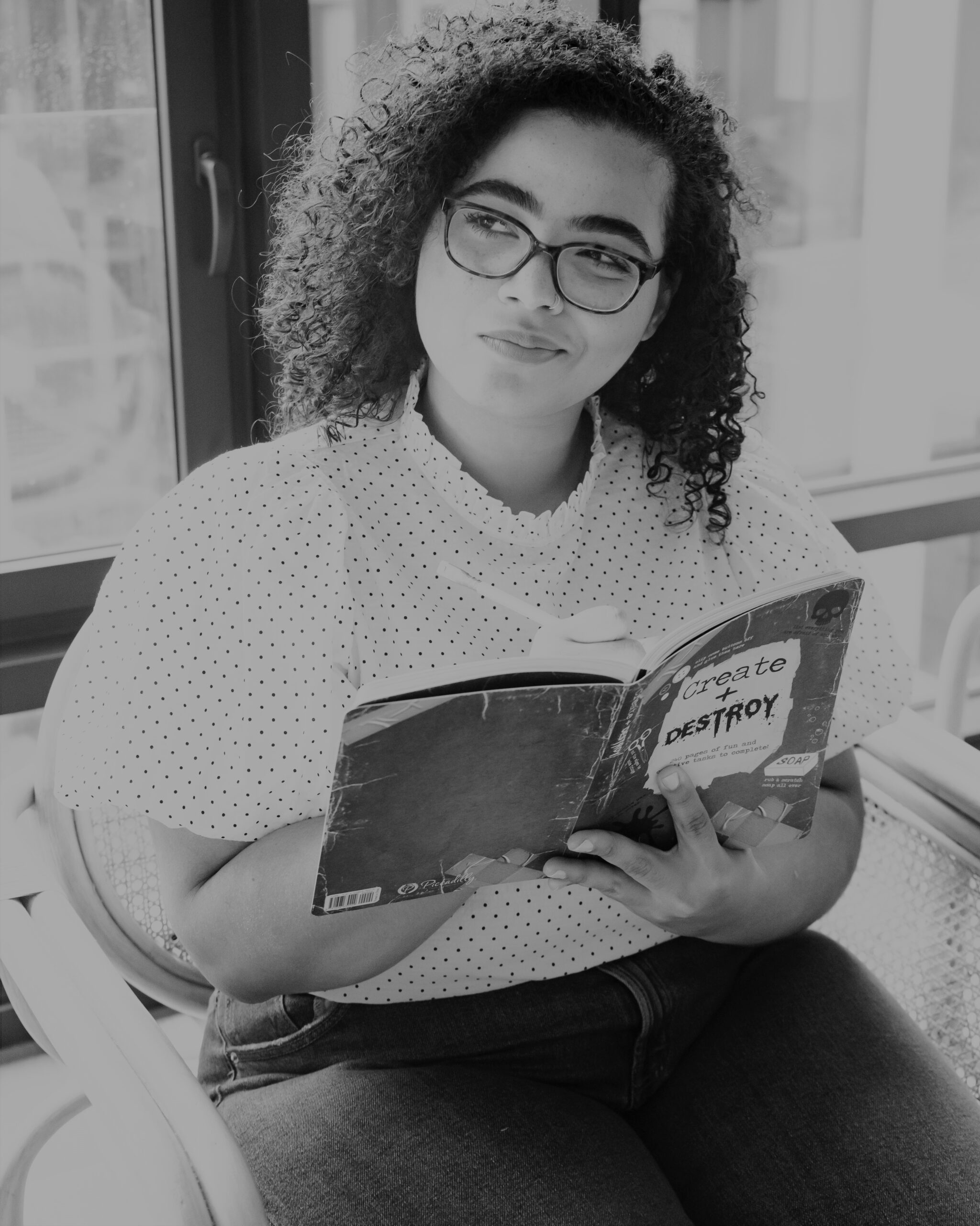 Woman with notebook in hand thinking pose